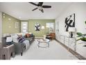 Inviting living room with modern decor, ceiling fan, and lots of natural light at 10022 Reunion Pkwy, Commerce City, CO 80022
