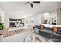 Bright, open concept living space with modern decor and light wood floors at 10022 Reunion Pkwy, Commerce City, CO 80022