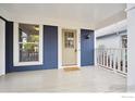 Inviting front porch with a charming entry door and ample space for outdoor seating at 1032 Pegasus Pl, Lafayette, CO 80026