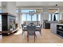 Bright dining room with modern chandelier, fireplace, and picturesque views at 11251 Lookout Dr, Longmont, CO 80504