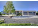 Contemporary home with a spacious three-car garage and a well-manicured front yard at 11251 Lookout Dr, Longmont, CO 80504