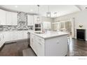 Modern kitchen features a center island, stainless appliances, and sleek backsplash at 11500 E 162Nd Dr, Brighton, CO 80602