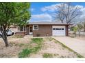 Charming brick home with attached garage and mature trees in a well-established neighborhood at 1153 Lincoln St, Longmont, CO 80501
