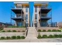 Modern townhome showcasing clean lines, stone accents, and private balconies with stone stairs at 1385 N King St, Denver, CO 80204