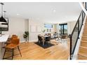 Bright open-concept living area with wood floors, kitchen with island seating at 1385 N King St, Denver, CO 80204