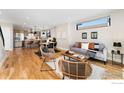 Open-concept living area with wood floors, kitchen, and modern furnishings at 1385 N King St, Denver, CO 80204