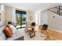 Cozy living room with ample natural light, sliding glass doors and sleek, modern finishes at 1385 N King St, Denver, CO 80204
