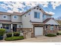 Charming townhouse with stone accents, attached garage, and well-maintained landscaping at 14000 Winding River Ct # T3, Broomfield, CO 80023