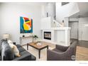 Bright living room featuring a modern fireplace, neutral decor, and contemporary furnishings at 14000 Winding River Ct # T3, Broomfield, CO 80023