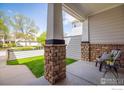 Inviting front porch with brick column detail and space for outdoor seating at 14000 Winding River Ct # T3, Broomfield, CO 80023