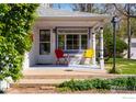 Quaint front porch with red and yellow chairs, offering a cozy and inviting entrance to this charming home at 1503 Balsam Ave, Boulder, CO 80304