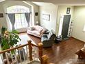Open-concept living area featuring hardwood floors and large windows at 1611 Red Mountain Dr, Longmont, CO 80504