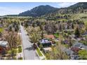 Charming street view showcasing the neighborhood, mountain views, and the home's unique architectural design at 1635 6Th St, Boulder, CO 80302