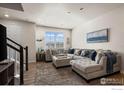 Comfortable living room featuring neutral tones, an oversized sofa, and a decorative whale art piece at 192 Ambrose St, Erie, CO 80516