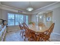 Cozy dining room with wood table, six chairs, and large window with blinds at 2050 Emerald Dr, Longmont, CO 80504