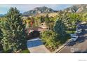Beautiful exterior showcasing a well-maintained home with a long driveway and mature trees at 2490 Vassar Dr, Boulder, CO 80305