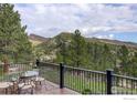 Outdoor deck featuring a dining table and views of the mountains at 2700 Crestridge Ct, Boulder, CO 80302