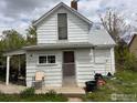 Cozy two-story home with a white exterior, small porch, and a pleasant backyard at 302 E Chester St, Lafayette, CO 80026