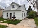 Quaint two-story house with a white exterior, gray roof, driveway, and well-maintained lawn at 302 E Chester St, Lafayette, CO 80026