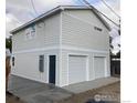 Modern two-car garage with clean white doors and a neatly finished exterior at 302 E Chester St, Lafayette, CO 80026