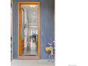 Warm and welcoming entryway featuring a hardwood door, tile floors, and an open view to the dining area at 3714 Ridgeway St, Boulder, CO 80301