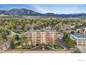 Wide angle view of a brick apartment building with a beautiful mountain view at 500 Mohawk Dr # 207, Boulder, CO 80303