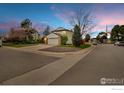 Corner lot home with a two-car garage and well-manicured landscaping, offering curb appeal at 5151 S Quintero St, Centennial, CO 80015