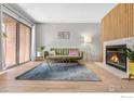 Living room with fireplace, hardwood floors, and sliding door to the outside at 540 S Forest St # 7-102, Denver, CO 80246