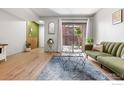 Open-concept living room with hardwood floors and access to outdoor patio at 540 S Forest St # 7-102, Denver, CO 80246