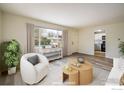 Bright living room featuring wood floors, large window, and comfortable staging at 740 Lotus Way, Broomfield, CO 80020