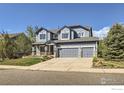 Beautiful two-story home with attached garage and manicured front lawn at 910 Pope Dr, Erie, CO 80516