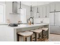Contemporary kitchen island with seating, modern lighting, and stainless steel appliances at 914 Eldorado Ln, Louisville, CO 80027
