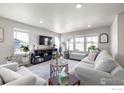 Cozy living room with plenty of natural light, neutral decor, and comfortable seating arrangements at 922 Colorado River Ave, Brighton, CO 80601