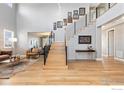 Bright entryway with hardwood floors, modern staircase, high ceilings, and stylish decor at 955 Horizon Ct, Erie, CO 80516