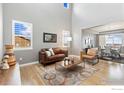 Spacious living room featuring hardwood floors, a comfortable sofa, and stylish decor at 955 Horizon Ct, Erie, CO 80516