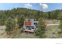 Secluded modern home featuring a large deck and mountain views at 1440 Reed Ranch Rd, Boulder, CO 80302