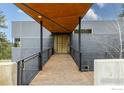 Inviting home entrance featuring a covered walkway and custom wood door at 1440 Reed Ranch Rd, Boulder, CO 80302