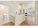 View of the bright entryway that showcases an open floor plan and hardwood floors at 1810 Signature Ct, Longmont, CO 80504