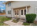 Cozy townhome entrance with covered porch and maintained garden at 1915 S Oakland Way, Aurora, CO 80014