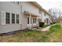Inviting townhome exterior with a well-kept lawn and pathway at 1915 S Oakland Way, Aurora, CO 80014