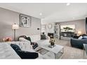 Elegant living room with modern decor, a fireplace, and stylish furnishings at 1915 S Oakland Way, Aurora, CO 80014