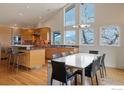 Open concept kitchen with adjacent dining area featuring hardwood floors, large windows, and a modern design at 230 Cactus Ct, Boulder, CO 80304