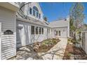 Charming exterior features a stone pathway leading to the entrance, surrounded by well-maintained landscaping and attractive architecture at 2672 Winding Trail Dr, Boulder, CO 80304