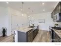 Bright kitchen features a large island, stainless steel appliances, and ample cabinet space for modern convenience at 2729 Bear Springs Cir, Longmont, CO 80503
