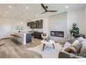 Open-concept living room showcases modern fireplace and flows into a kitchen with a large center island at 2729 Bear Springs Cir, Longmont, CO 80503