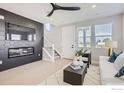 Living room features a black accent wall with fireplace, white sofa, and stylish decor at 2759 Bear Springs Cir, Longmont, CO 80503