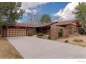 Well-maintained single-story brick home with long driveway and attached garage at 285 Hopi Pl, Boulder, CO 80303