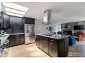 Spacious kitchen featuring stainless appliances, dark cabinets and an island with a granite countertop perfect for entertaining at 285 Hopi Pl, Boulder, CO 80303