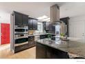 Modern kitchen features dark cabinets, granite countertops, and stainless steel appliances at 285 Hopi Pl, Boulder, CO 80303