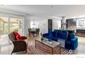 Open concept living space, seamlessly integrating the kitchen with modern furnishings and abundant natural light from surrounding windows at 285 Hopi Pl, Boulder, CO 80303
